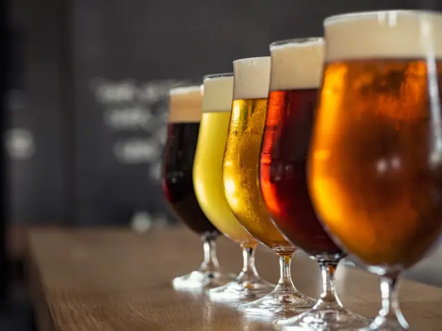 Flight of craft beers showcasing a variety of styles and flavors providing a diverse and flavorful experience for beer connoisseurs.