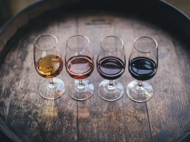Flight of wine tastings featuring a selection of exquisite varietals, presented in elegant glasses and accompanied by tasting notes, offering a delightful sensory experience for wine enthusiasts.
