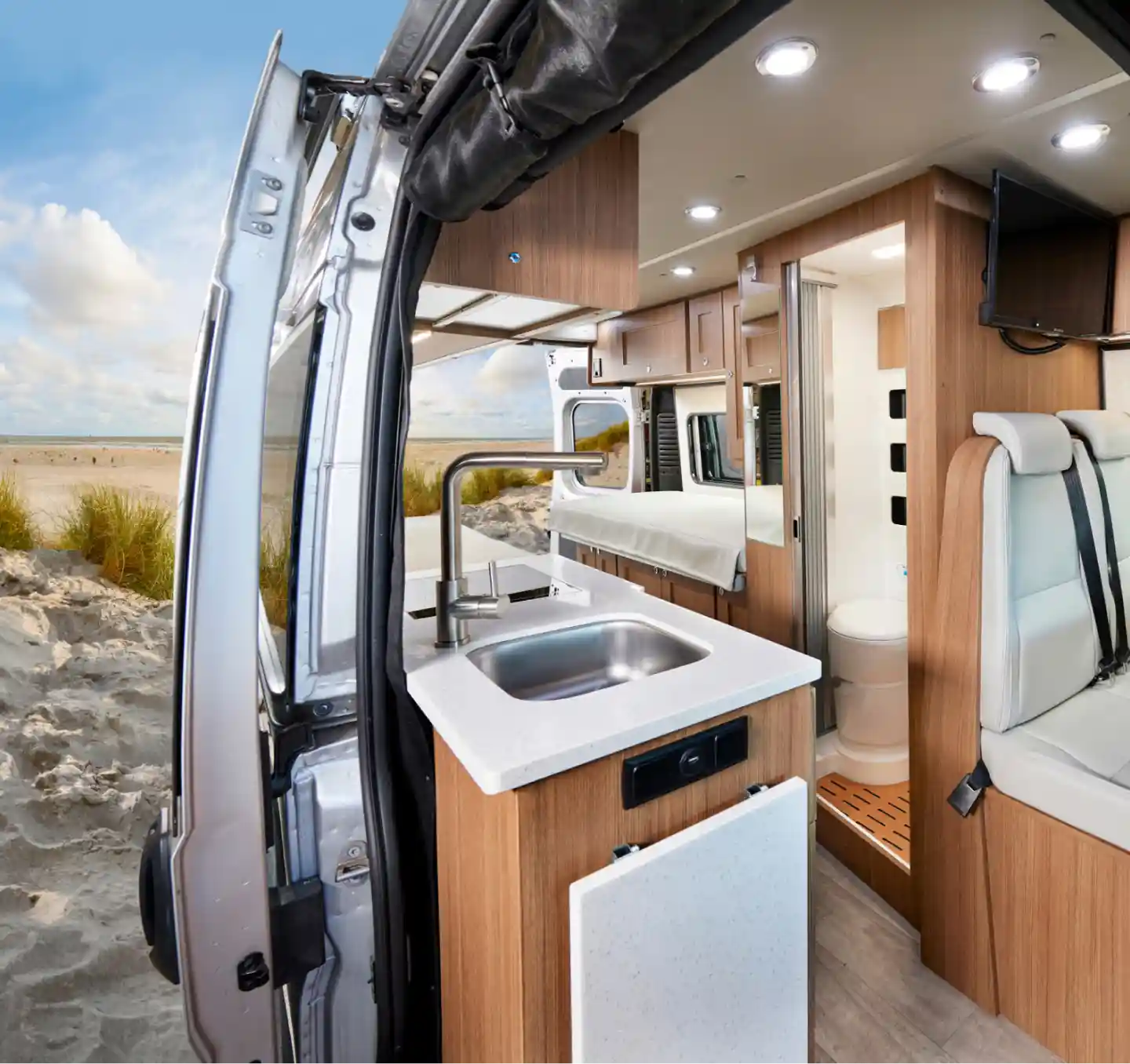 Interior of a motorhome showcasing cozy living quarters, compact kitchenette, and clever storage solutions, providing comfort and convenience for travelers exploring the open road.