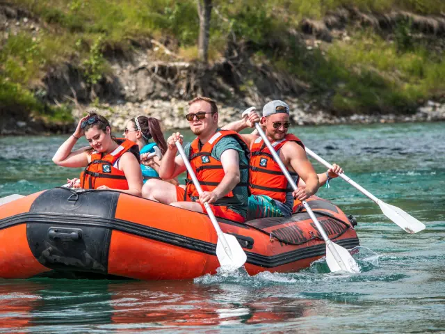 Group of friends enjoying a leisurely river float on inflatable rafts, surrounded by scenic nature and basking in the sun, creating unforgettable memories of summer fun.