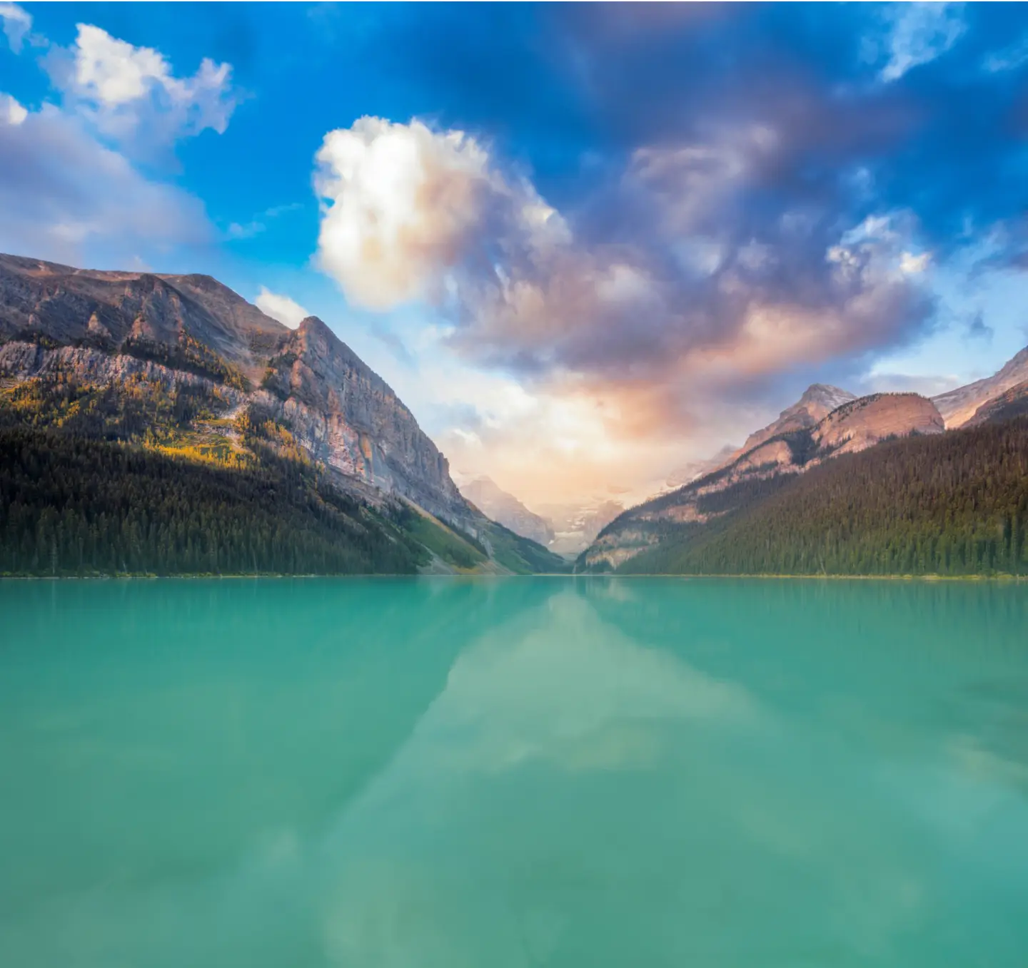Majestic view of Lake Louise in Banff National Park, Alberta, Canada, surrounded by towering snow-capped mountains and vibrant turquoise waters